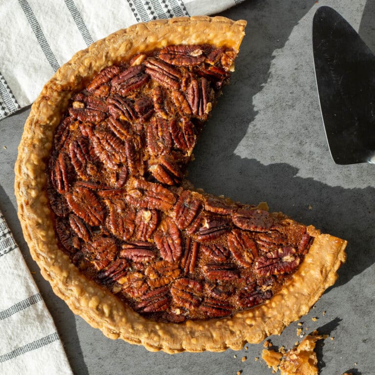 overhead view of pecan pie with a quarter chunk cut out