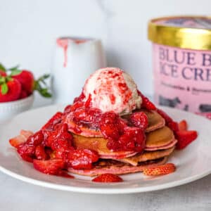 pancakes topped with strawberry compote and ice cream