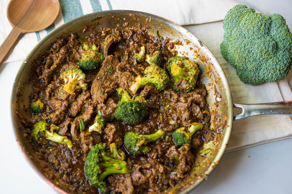 a skillet full of beef and broccoli