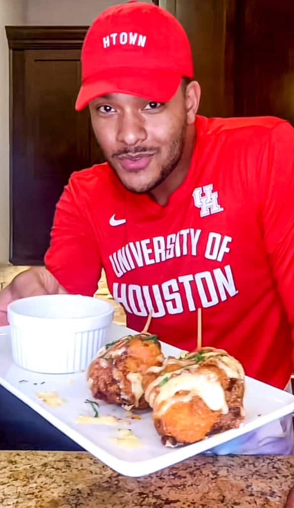 Kolby Kash holding Fried Lobster Tail on a plate