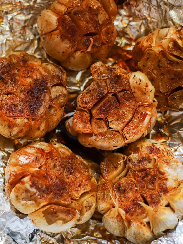 close up of 6 roasted garlic bulbs
