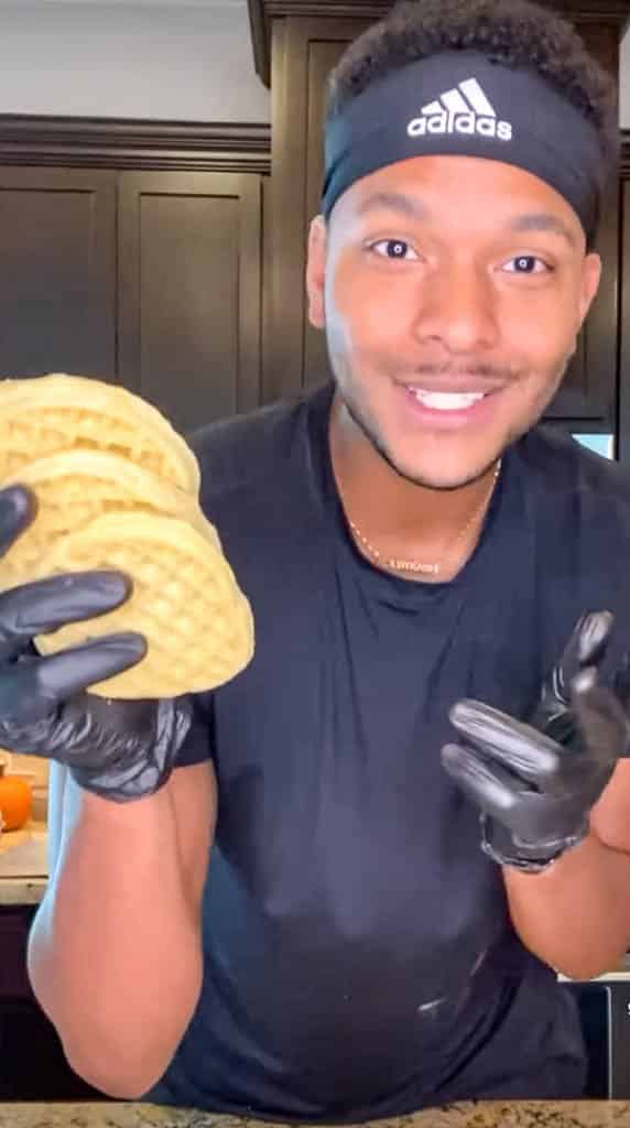 Kolby holding waffles with gloved hands