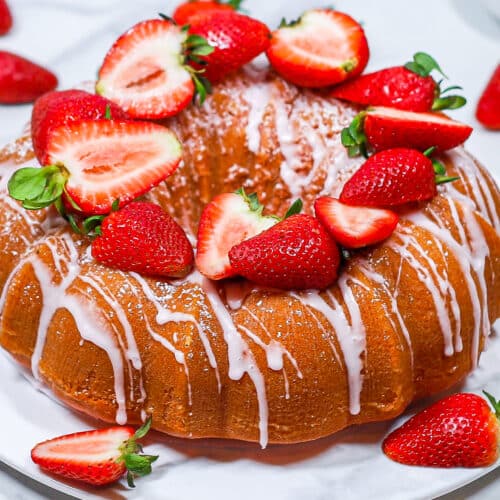 strawberry bundt cake topped with fresh strawberries and icing