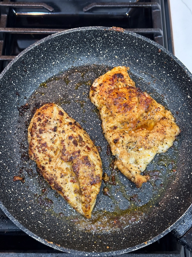 cooked chicken breasts in skillet