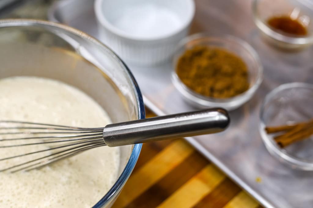 sauce for bread pudding in a bowl with a whisk