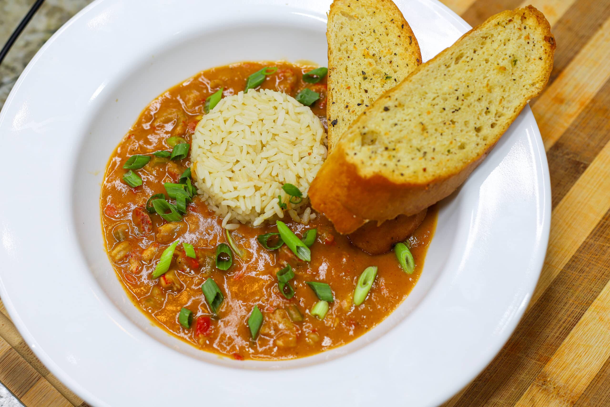 Bowl of crawfish etouffee with garlic bread