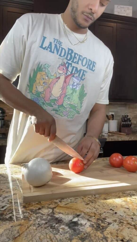 chopping tomato for the chicken Tinga sauce