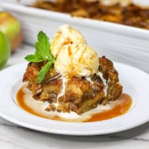 bread pudding on a plate with a scoop of ice cream