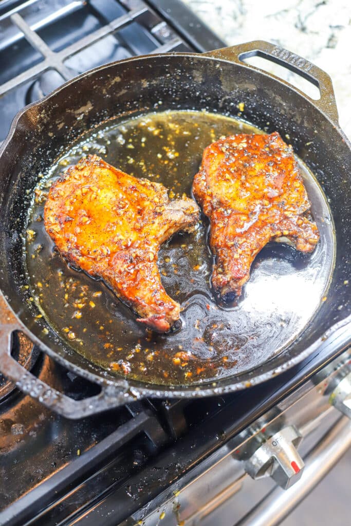 pork chop cooking in honey garlic glaze