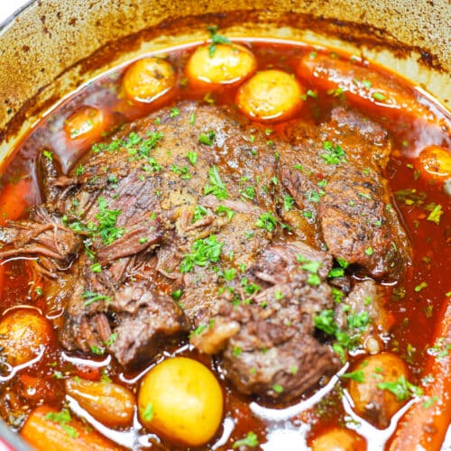 Pot roast with carrots and potatoes in dutch oven