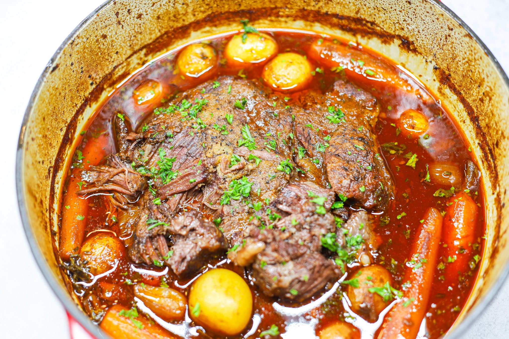 Pot roast with carrots and potatoes in dutch oven