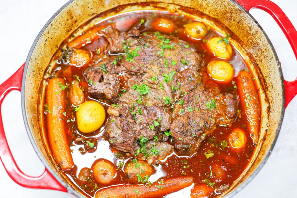 Pot roast with carrots and potatoes in dutch oven