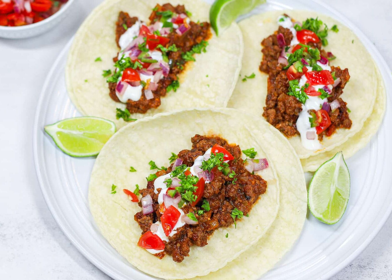 finished ground beef tacos with a side of pico de Gallo