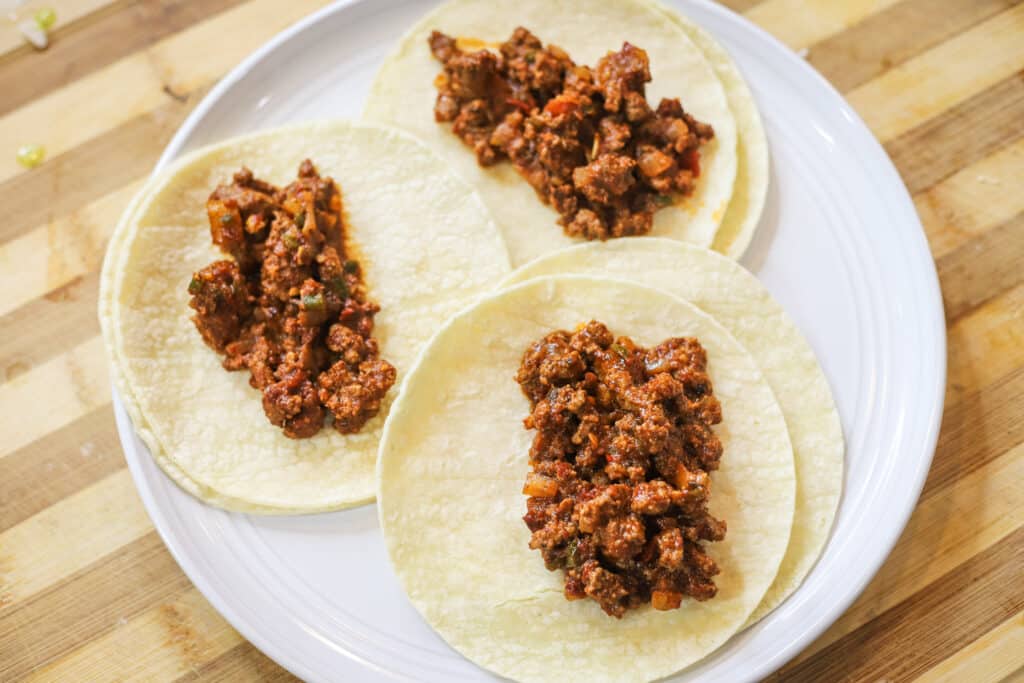 ground beef taco with white corn tortilla