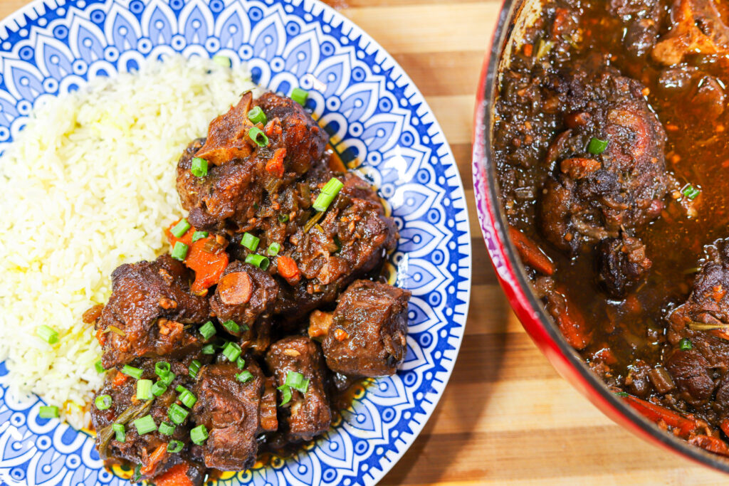 Southern Oxtails plated with rice and topped with green onion