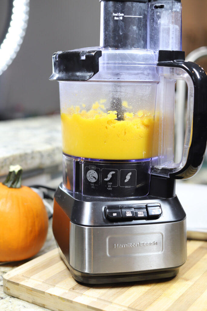 Food Processor with pumpkin puree in it