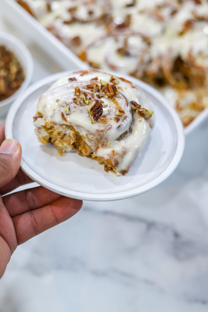 Sweet Potato Cinnamon Rolls indivdual iced in hand