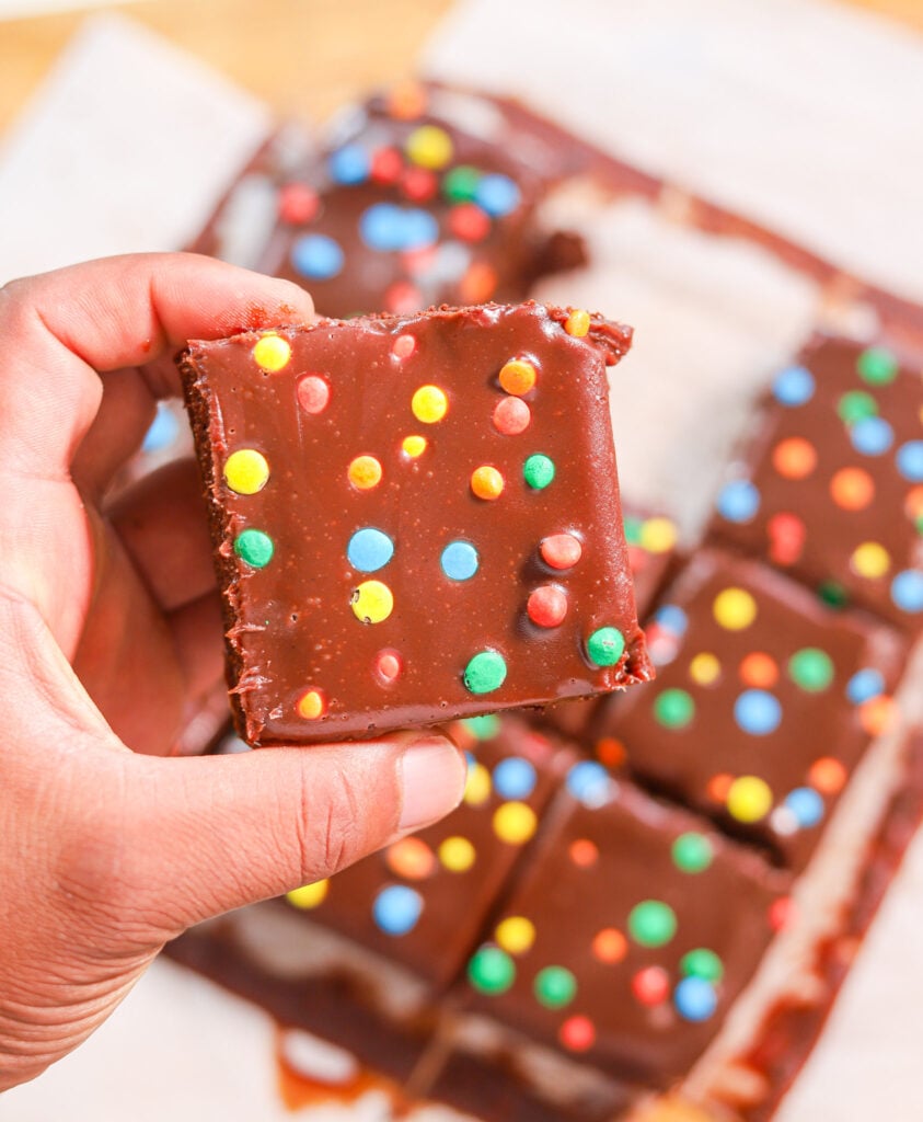 Fudgy homemade Cosmic Brownies with thick chocolate ganache and rainbow candies